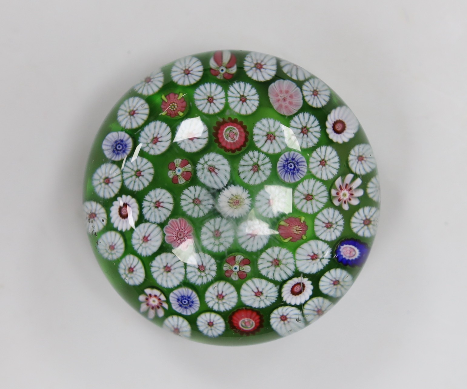 A 19th century French glass millefleur spaced cane paperweight, 8.5cms diameter